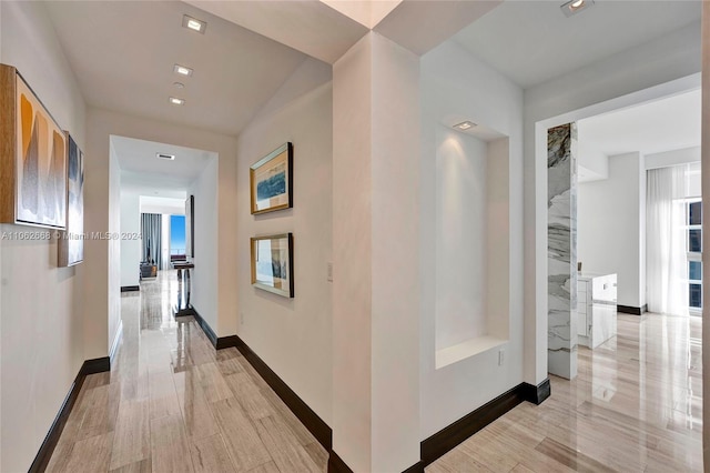 hall featuring a wealth of natural light and light wood-type flooring