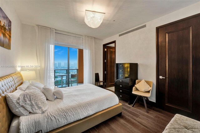 bedroom with dark wood-type flooring