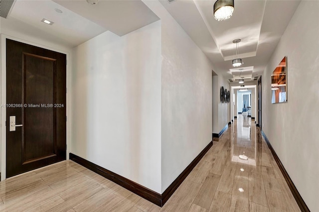 corridor with light hardwood / wood-style flooring