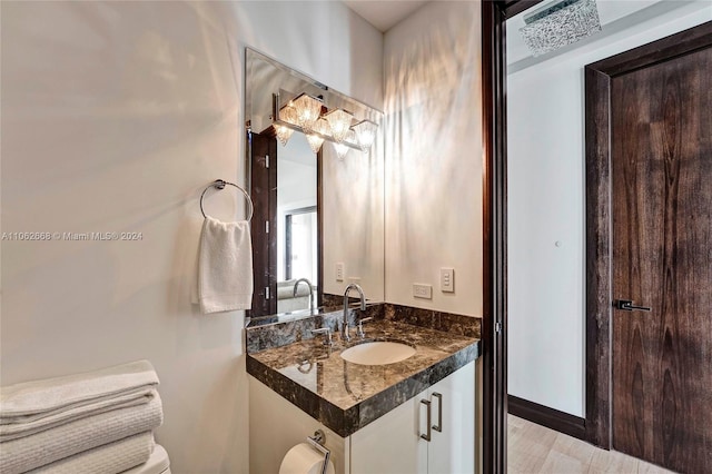 bathroom featuring vanity, toilet, and hardwood / wood-style flooring