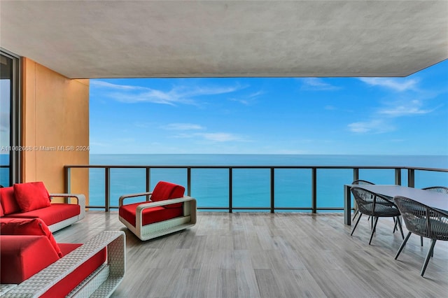 balcony featuring a water view and an outdoor hangout area