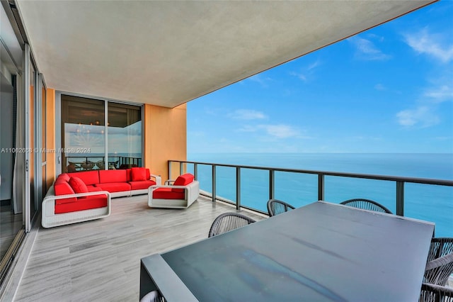 balcony with a water view and outdoor lounge area