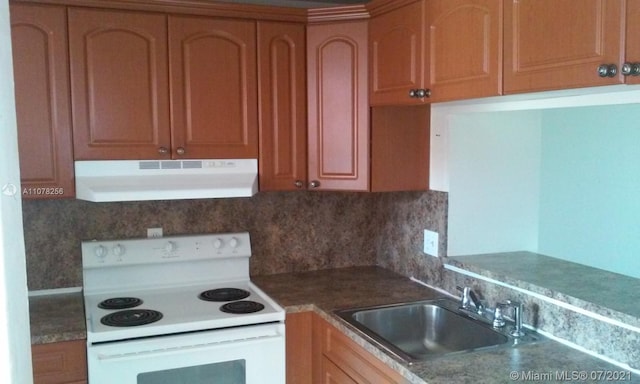 kitchen with white range with electric stovetop, decorative backsplash, and sink