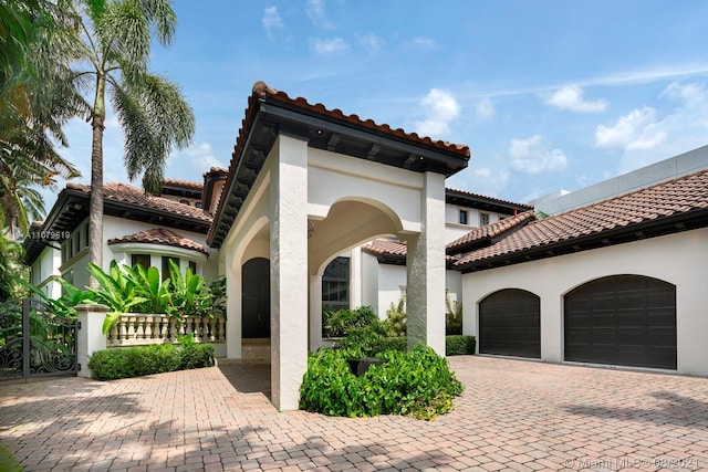 mediterranean / spanish-style home with a garage