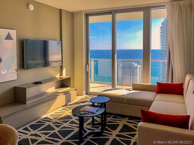 living room with a water view and light colored carpet