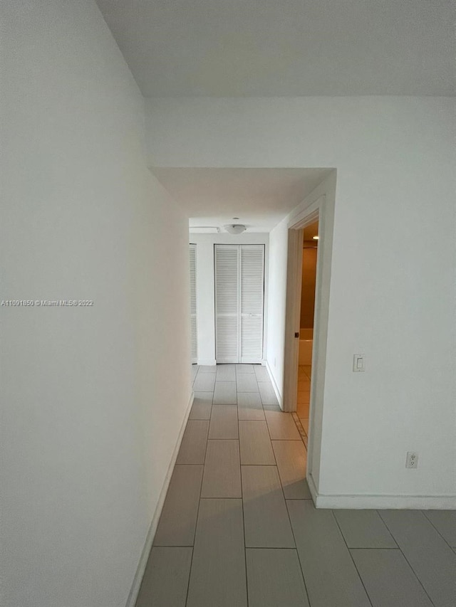 hallway featuring light tile flooring