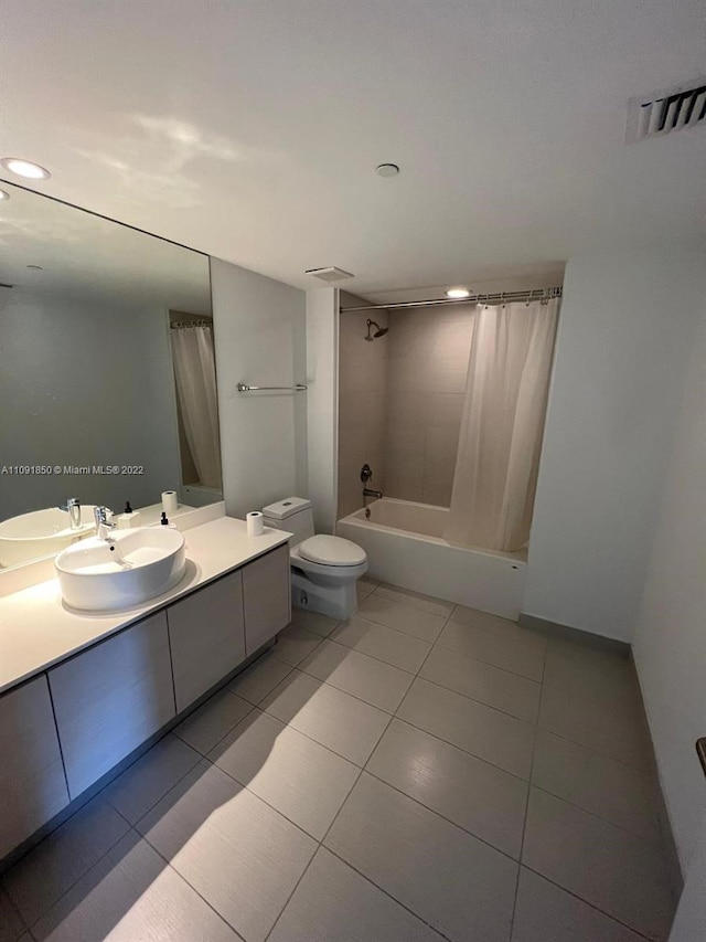 full bathroom with tile floors, toilet, vanity, and shower / bathtub combination with curtain