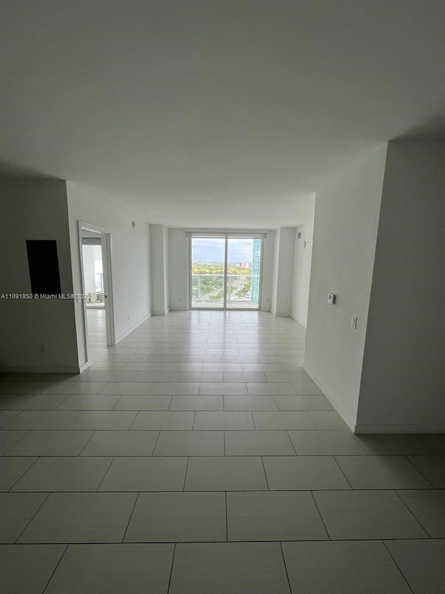 unfurnished room featuring light tile flooring