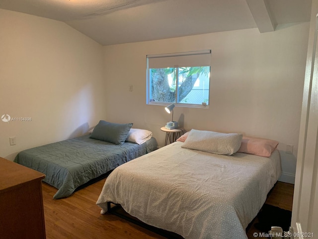 bedroom with vaulted ceiling and hardwood / wood-style flooring