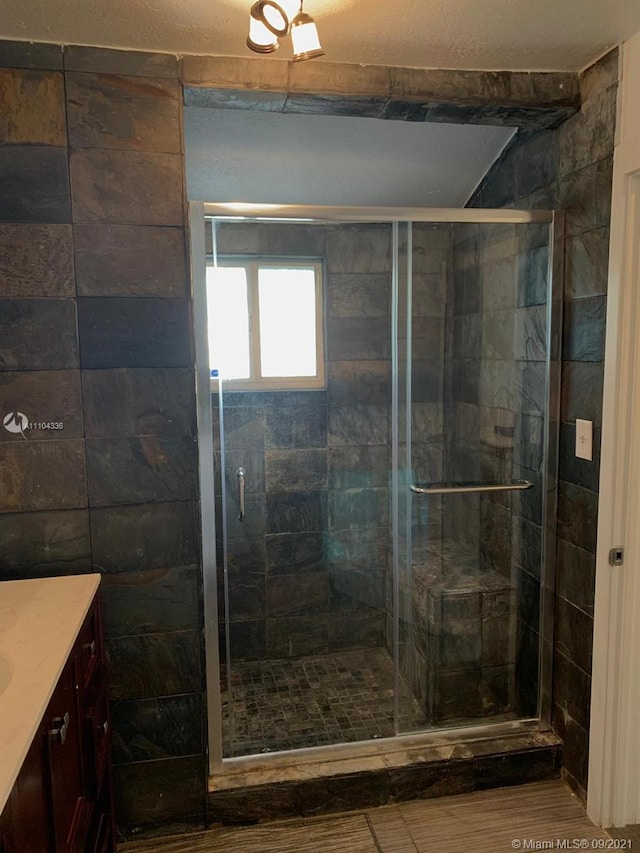 bathroom with walk in shower and vanity