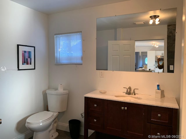 bathroom with toilet and vanity