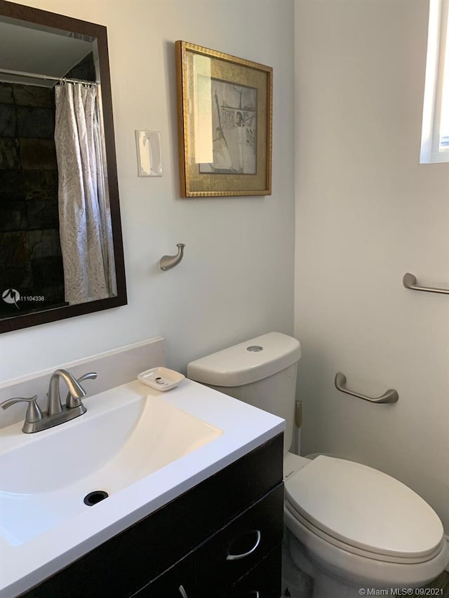 bathroom featuring toilet and vanity