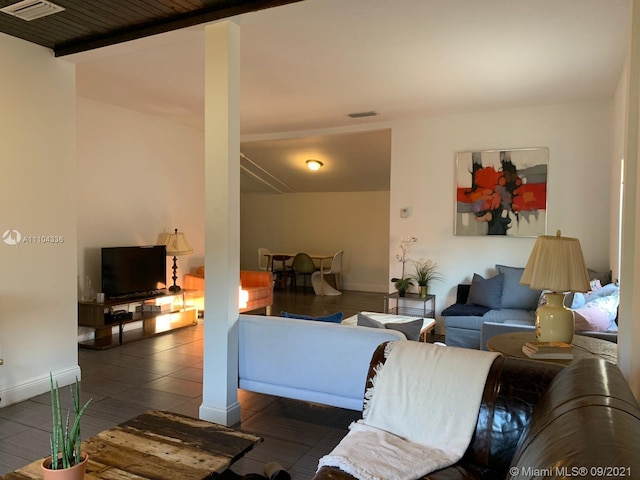 tiled living room with beamed ceiling