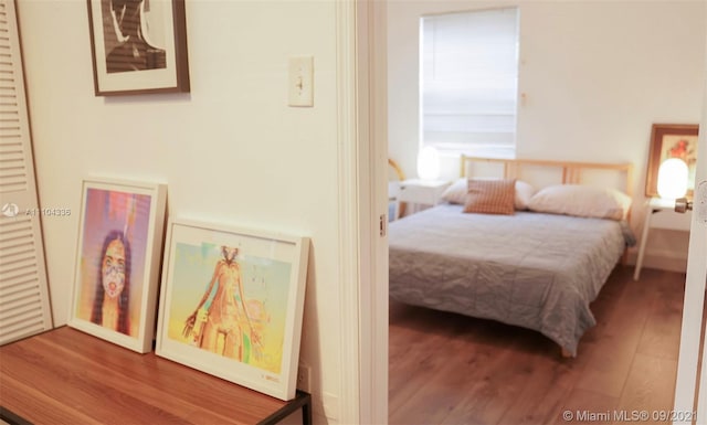 bedroom with dark hardwood / wood-style floors