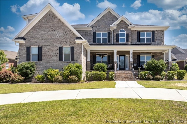 craftsman inspired home featuring a front yard and a porch