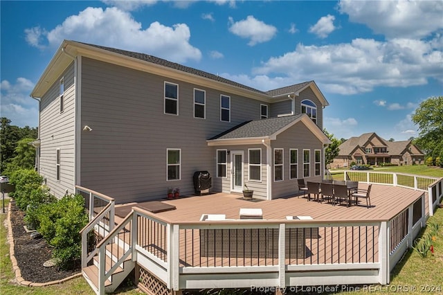 back of house featuring a deck