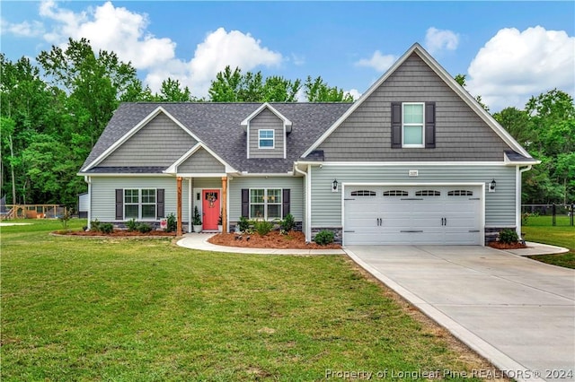 craftsman inspired home featuring a garage and a front lawn