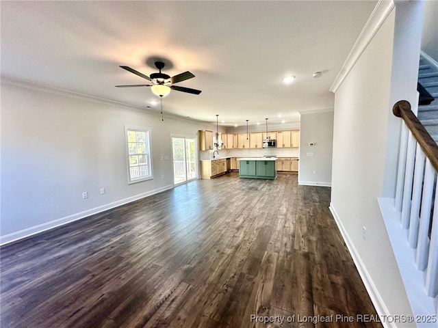 unfurnished living room featuring dark wood-type flooring, ornamental molding, and ceiling fan