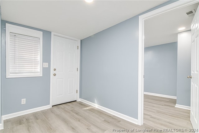 empty room with light hardwood / wood-style floors