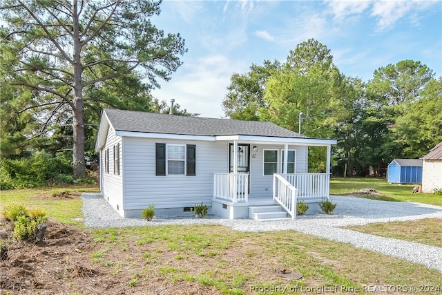 view of front of property with a porch and a front yard