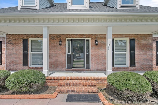 entrance to property featuring covered porch