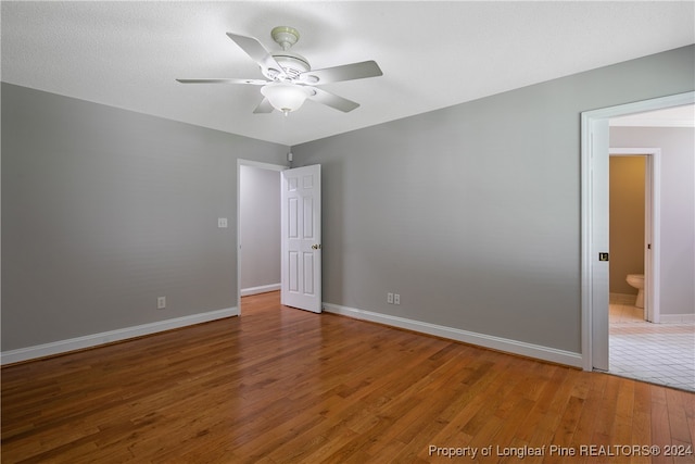 unfurnished room with wood-type flooring and ceiling fan