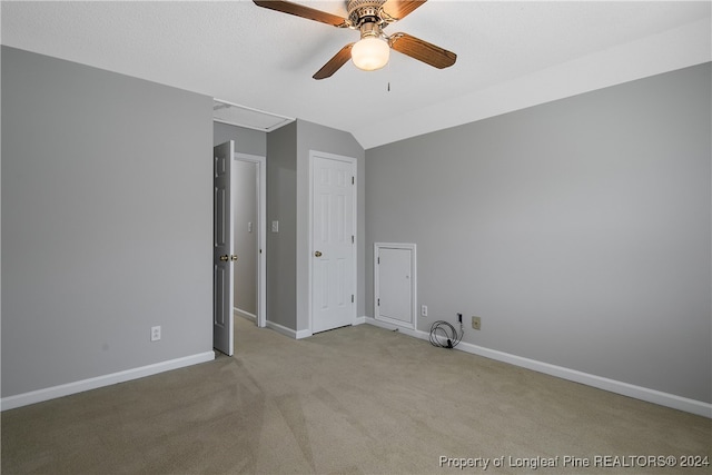 carpeted empty room featuring lofted ceiling and ceiling fan