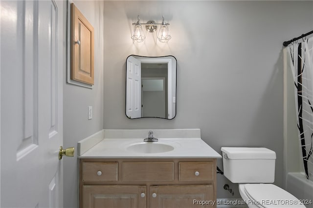 full bathroom featuring vanity, toilet, and shower / tub combo with curtain