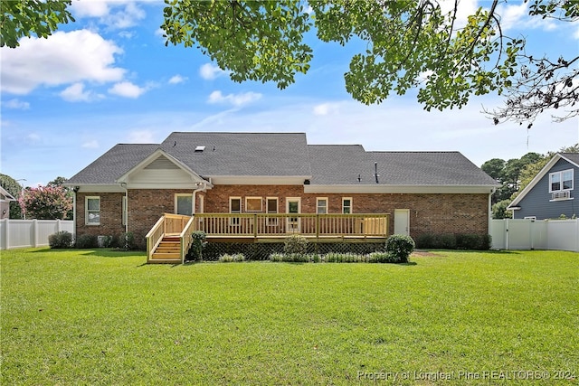 back of house with a yard and a deck