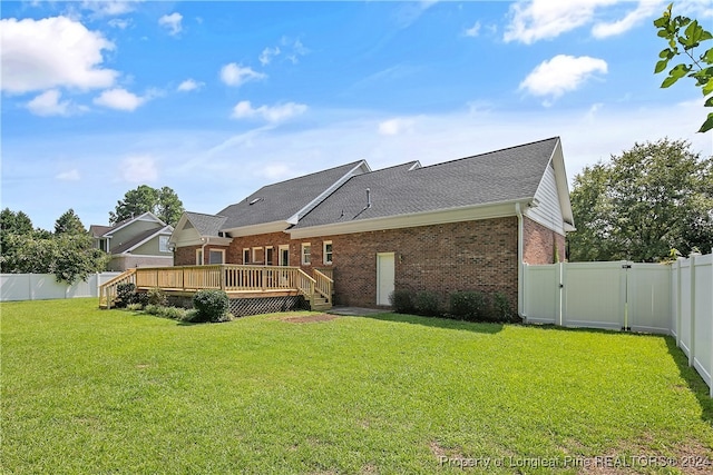 back of house with a yard and a deck