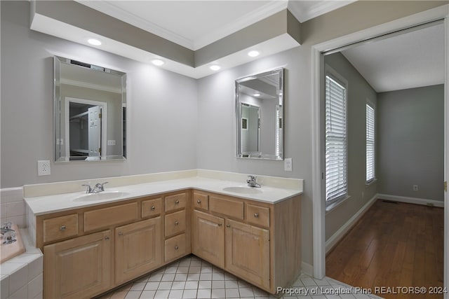 bathroom featuring crown molding, double sink vanity, and tile patterned floors