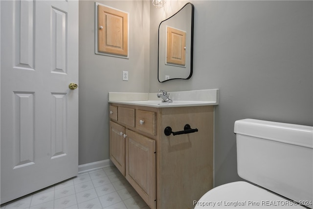 bathroom featuring vanity, toilet, and tile patterned floors