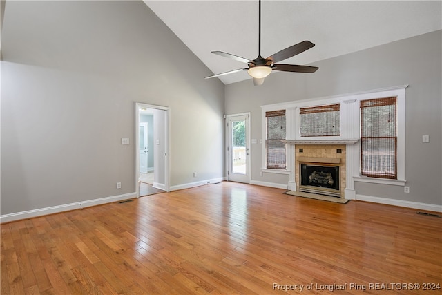 unfurnished living room featuring high vaulted ceiling, ceiling fan, and light hardwood / wood-style flooring