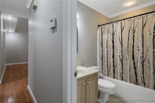 full bathroom with toilet, ornamental molding, vanity, wood-type flooring, and shower / tub combo