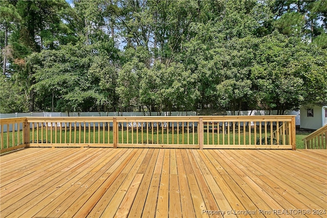 wooden deck with a lawn