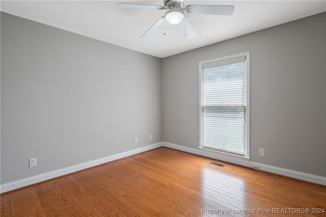 spare room featuring hardwood / wood-style floors and ceiling fan