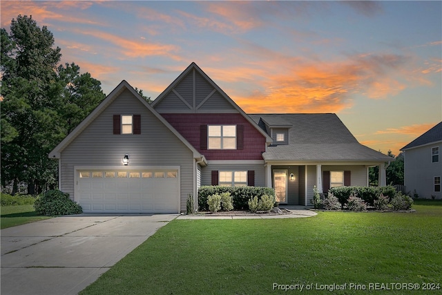 view of front of house featuring a garage and a lawn