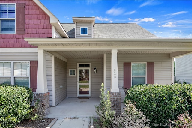 view of exterior entry with a porch