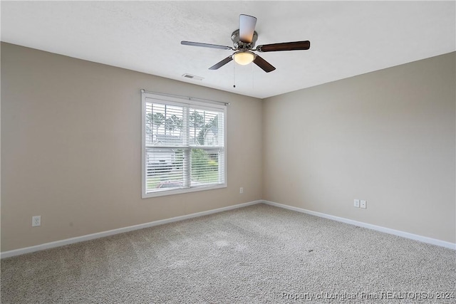 carpeted spare room with ceiling fan