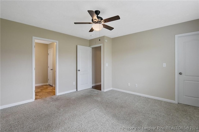 unfurnished bedroom featuring light colored carpet and ceiling fan