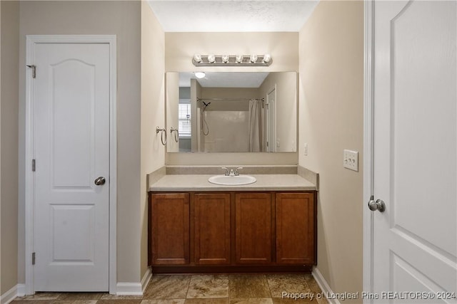 bathroom featuring vanity and a shower with shower curtain