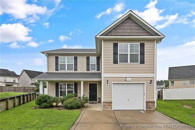 view of front of house with a garage and a front yard