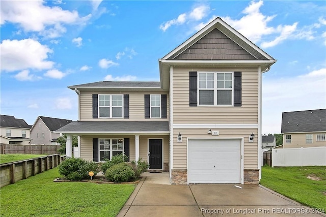 view of front of house featuring a garage and a front lawn