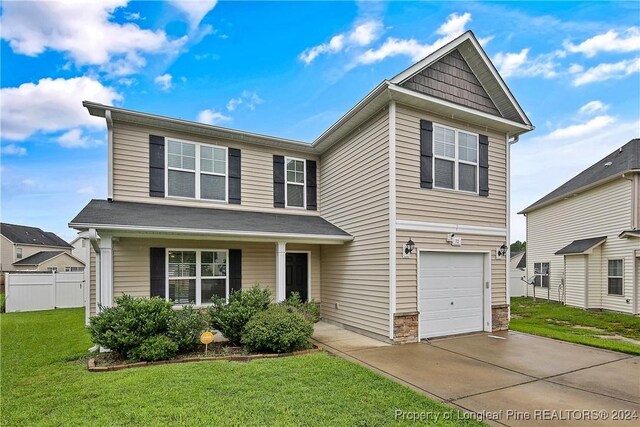 view of front property with a garage and a front yard