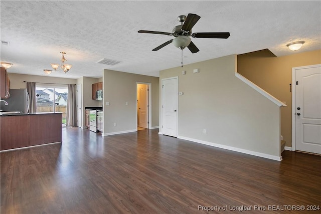 unfurnished living room featuring dark hardwood / wood-style flooring, ceiling fan with notable chandelier, and a textured ceiling