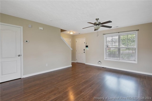 unfurnished room featuring dark hardwood / wood-style flooring, a textured ceiling, and ceiling fan