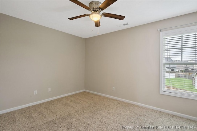 unfurnished room featuring ceiling fan and carpet flooring