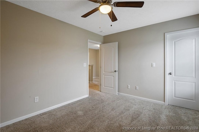 unfurnished bedroom featuring ceiling fan and light carpet