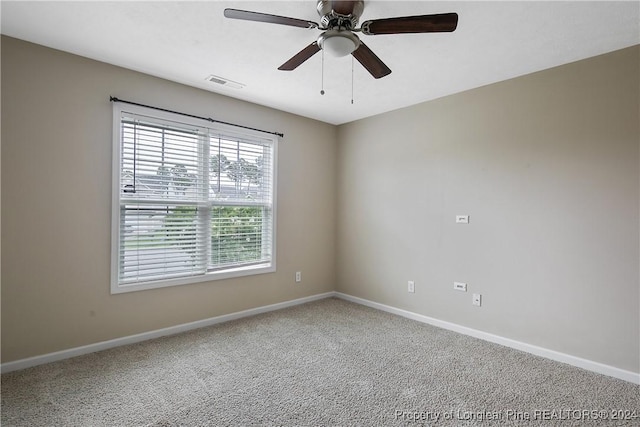 empty room with ceiling fan and carpet flooring