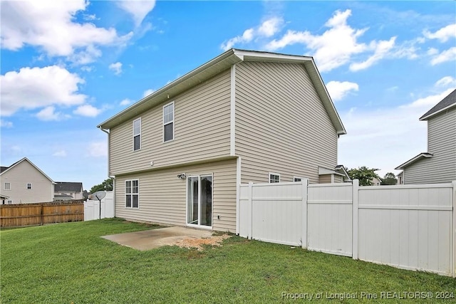 back of house with a yard and a patio area